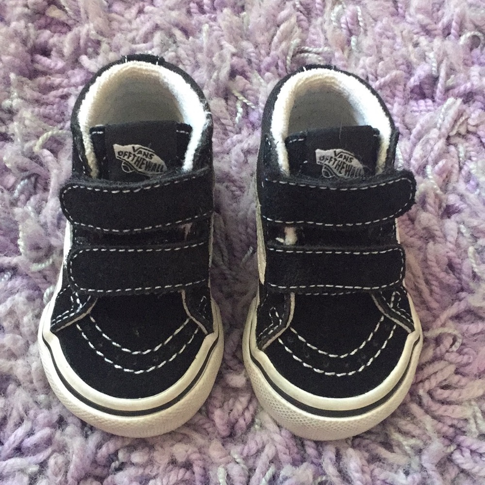 Black and white high top vans